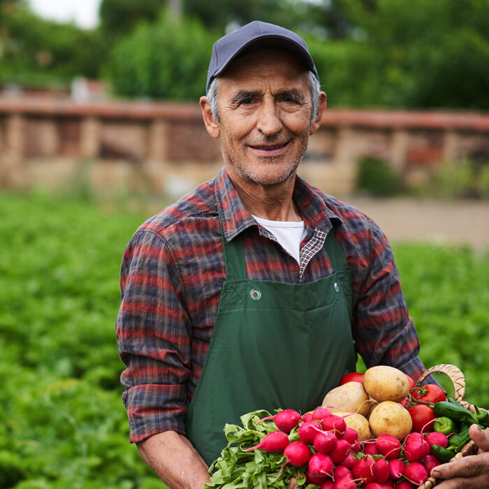 A farmer holding a basket of vegetables