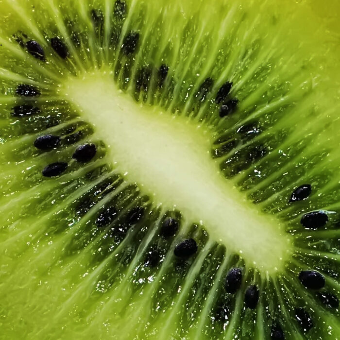 A closeup image of a kiwi sliced in half