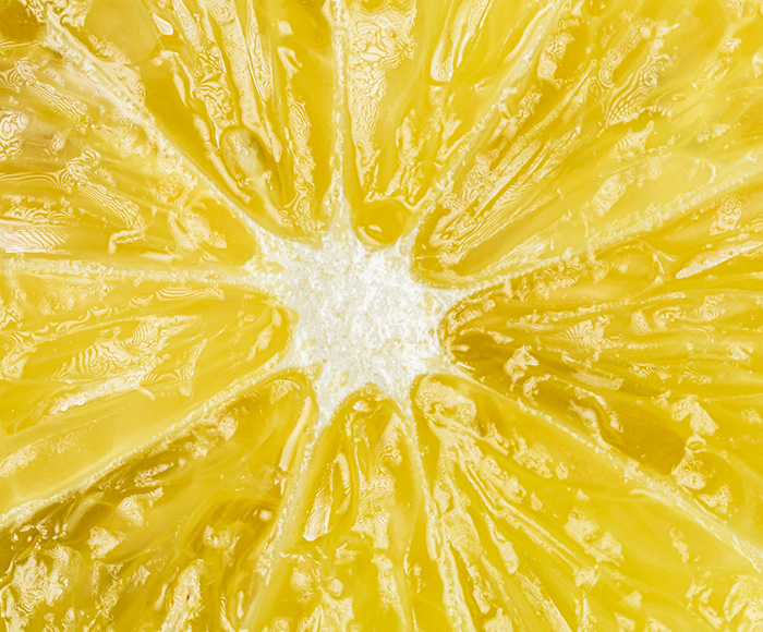 A close up image of a lemon cut open